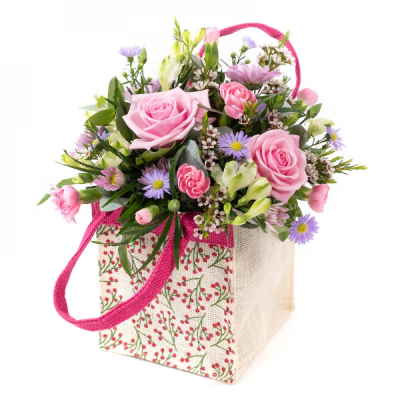 A Little Something - Show your affection with this mouth-watering mix of classical flowers delivered in a delightful gift bag or box.